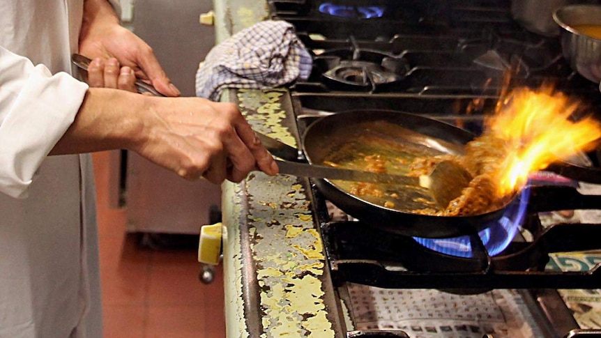 A chef cooks in a restaurant.