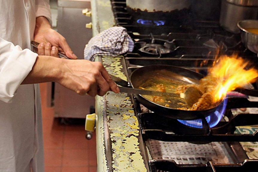 A chef cooks in a restaurant.