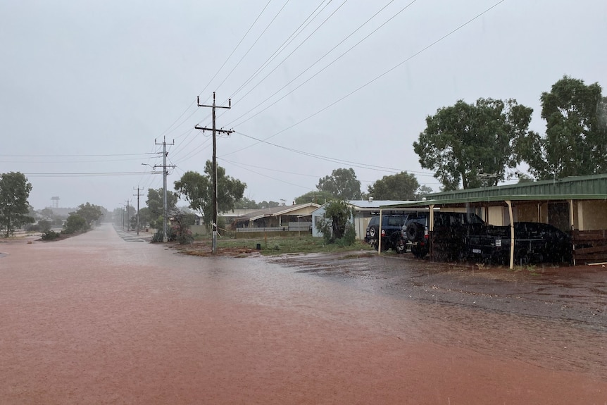 A flooded street in an outback town.  