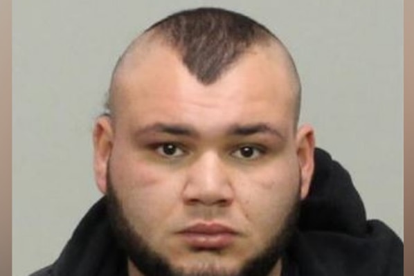 An official police photo of a man wearing a black hoodie.