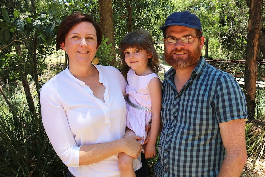 Parents Rosie Hays, holding her daughter four-year-old Mirrin, with father Sam Stabler in a park.