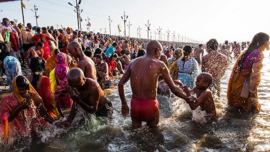 Hindu devotees bathe on the banks of Sangam during the Kumbh Mela festival.