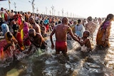 Hindu devotees bathe on the banks of Sangam during the Kumbh Mela festival.