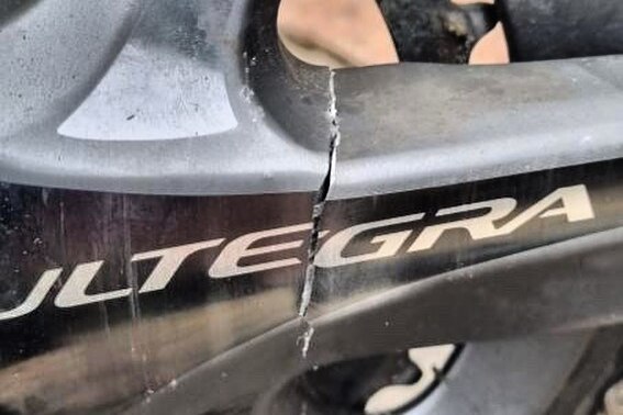 A broken crankset on a Shimano bike.