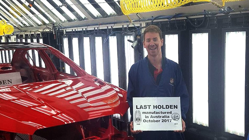 Holden worker Kane Butterfield with the last car produced at the Elizabeth plant on October 19, 2017.