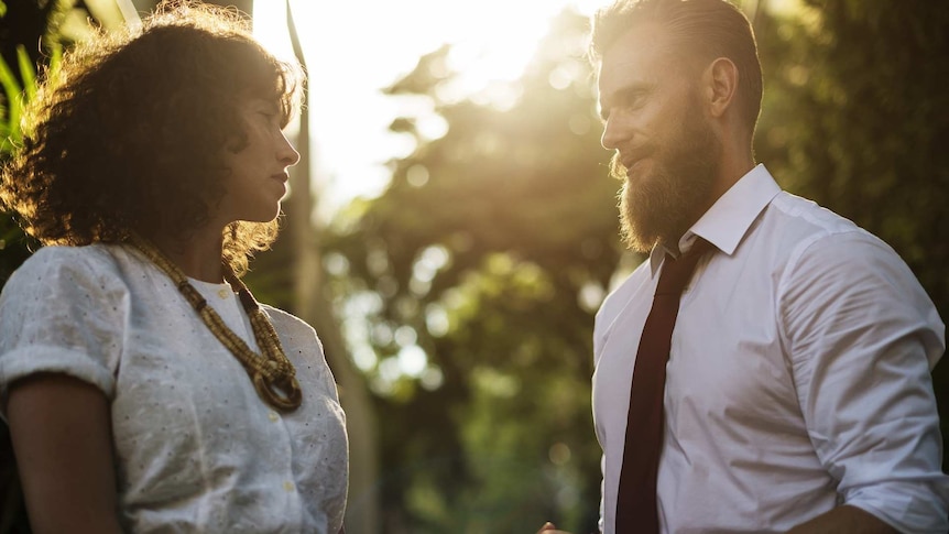 A lady and a man talking to each other