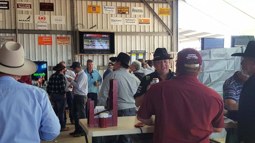 Crowds in an outback betting ring.