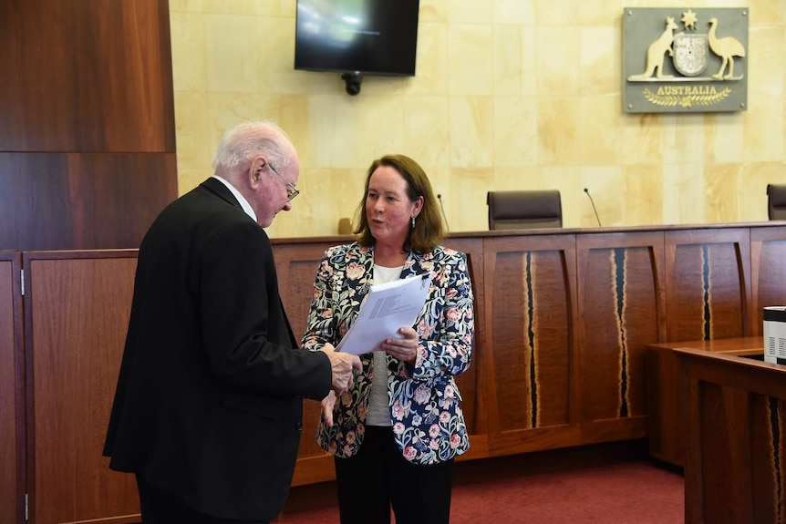 Justice Debra Mortimer hands over native title judgment.