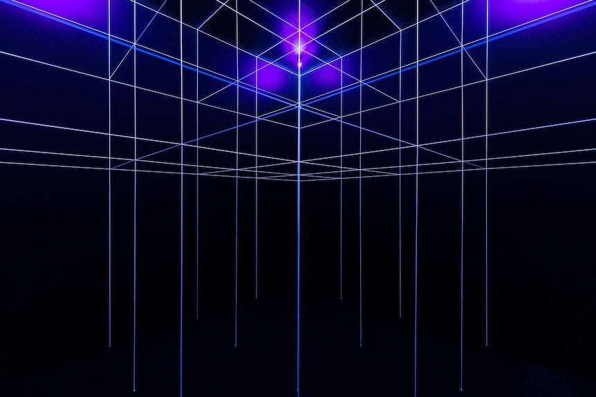 Dark room intersected by bright blue and white 'beams' of light in a grid-like formation.