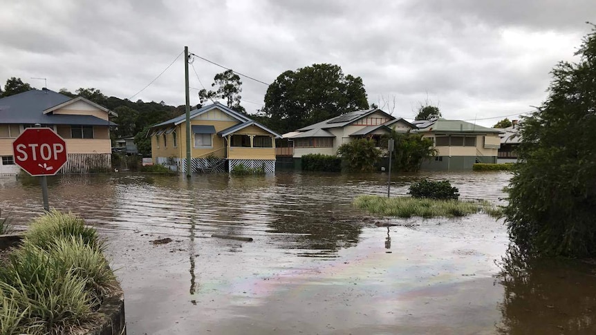 Woolworths petrol station leakage, reflected in floodwaters in the town.