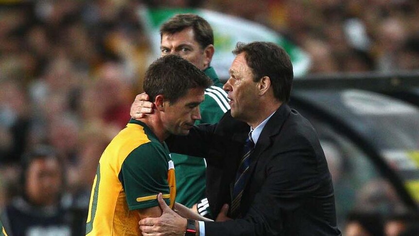 Left out ... Holger Osieck (R) gives Harry Kewell a hug during a 2010 friendly