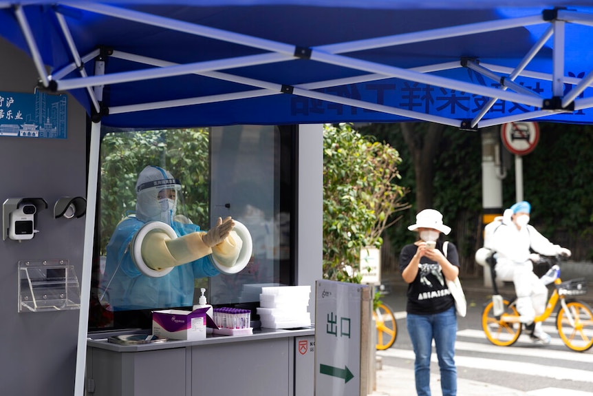 Man in a covid testing booth.