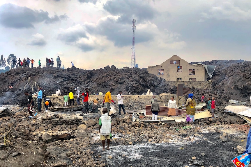 People sift through lava wreckage in Congo
