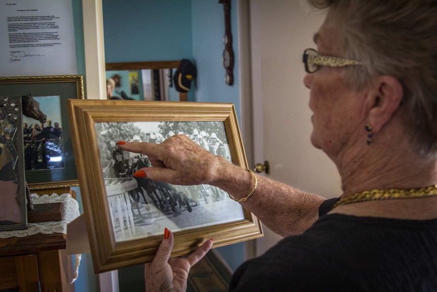 Lady looking at a photo.