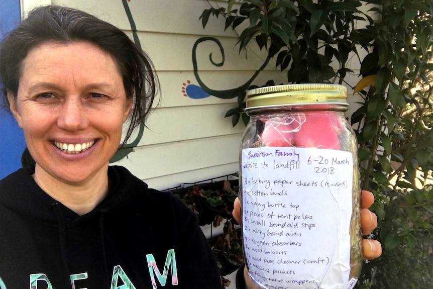 Mia Swainson with a jar of her family's waste.