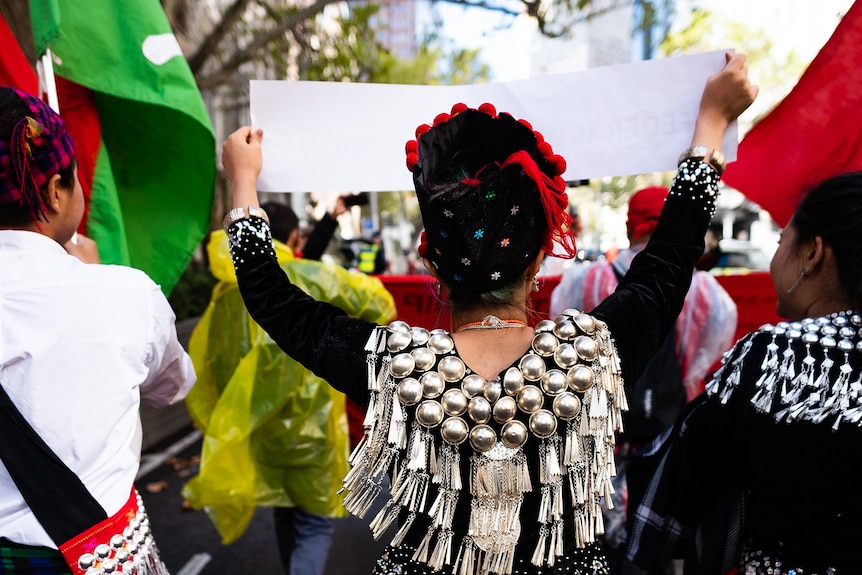 A woman in traditional Kachin clothing walks during a protest.