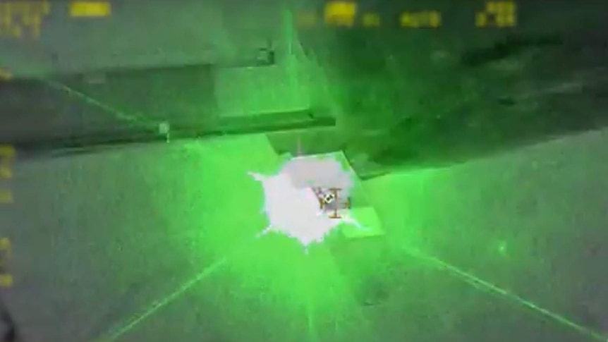 The moment a laser beam illuminates the police helicopter.