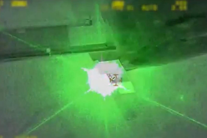 The moment a laser beam illuminates the police helicopter.