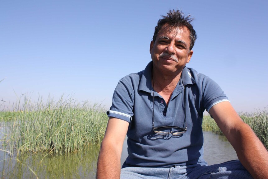 Jassim Al-Asadi sits in a boat in the marshlands