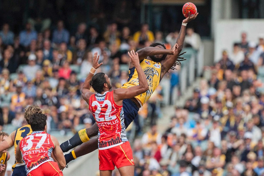 West Coast's Nic Naitanui and Gold Coast's Tom Nicholls contest a high ball