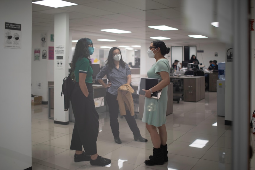 Three women speaking.