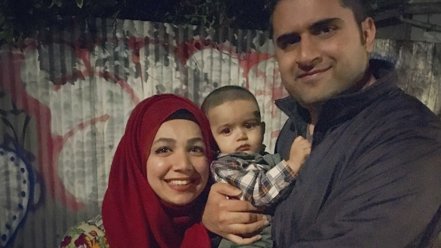 Bushra Zainuddin and her husband Zain Zafar smile as they pose for a photo with their son.