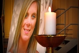 A photo of Tara Costigan next to a candle at her funeral service.