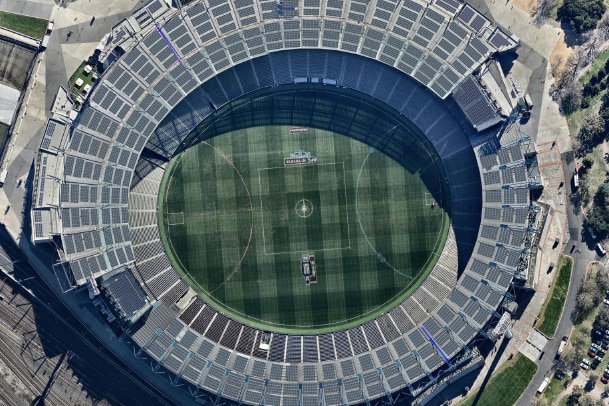 An aerial photo of the MCG stadium with solar panels on the roof area