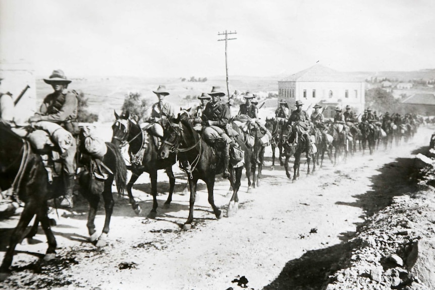 An Australian Light Horse regiment passes through Jerusalem mounted on horseback.