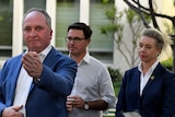 Barnaby Joyce gestures while answering questions as David Littleproud and Bridget McKenzie look on behind him