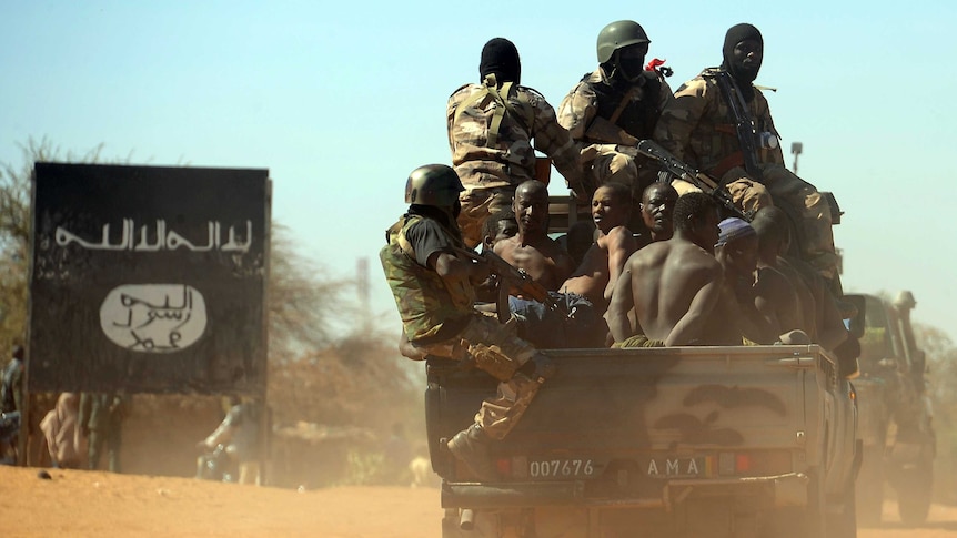 Malian soldiers transport suspected Islamist rebels on after arresting them north of Gao