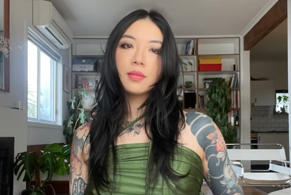 Thao Tran looking at the camera with tatoos