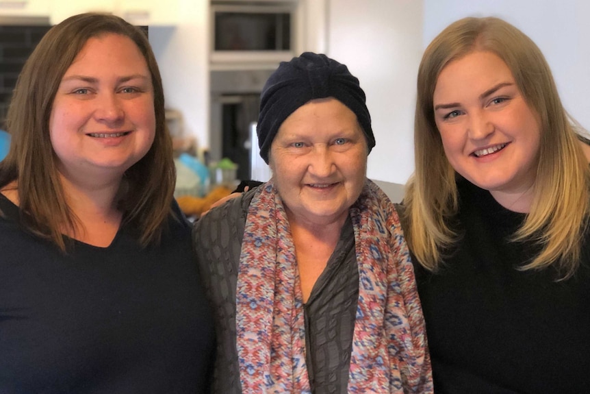 Kerry Robertson stands between her two daughters Jacqui Hicks and Nicole Robertson