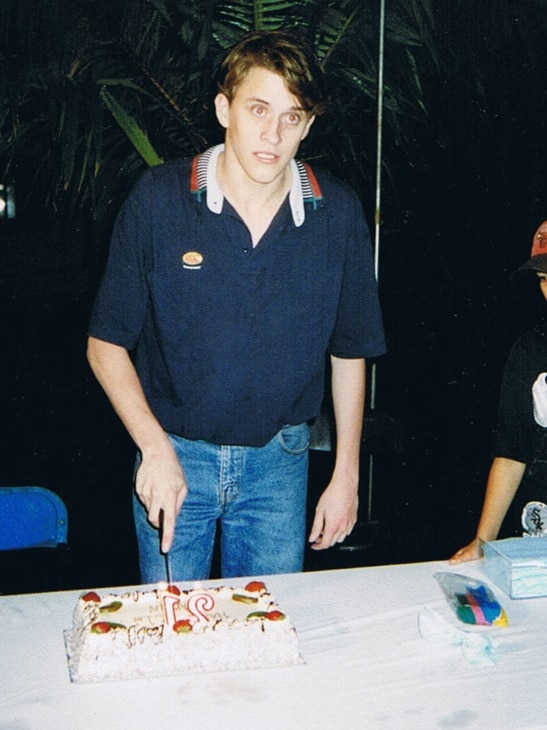 Darren cuts his 21st birthday cake.