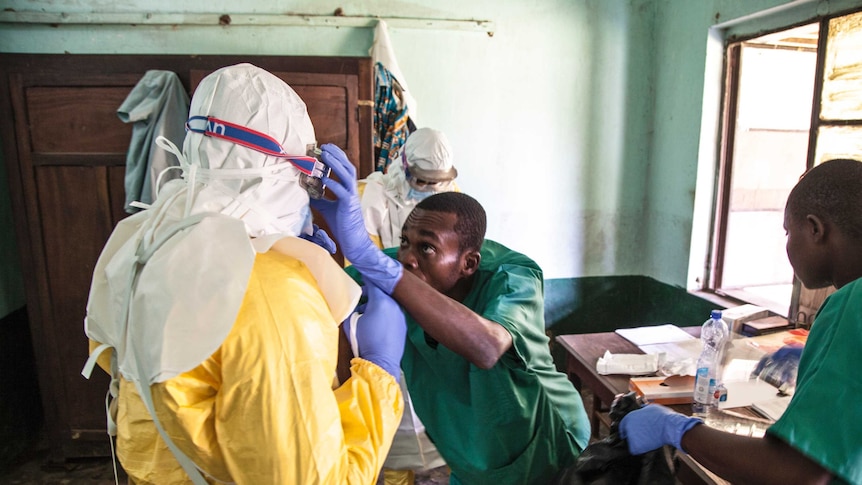 Health workers don protective clothing in DRC. They are covered all over and wearing goggles.