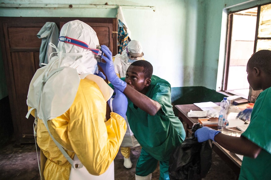 Health workers don protective clothing in DRC. They are covered all over and wearing goggles.