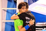 Epic battle ... Rafael Nadal and Novak Djokovic embrace after their thrilling final (ABC News: Tony Trung)