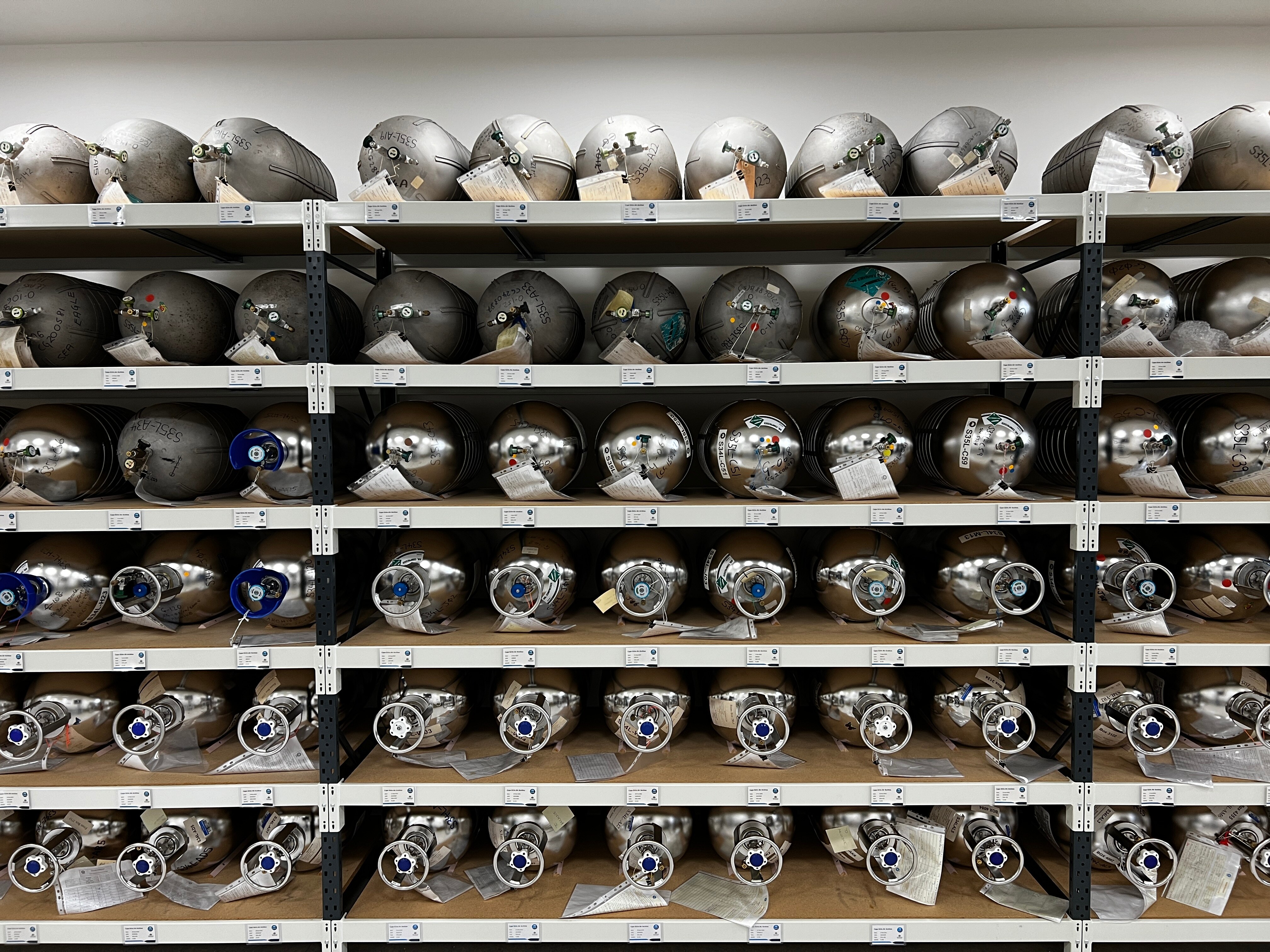 A man stands in front of air tanks