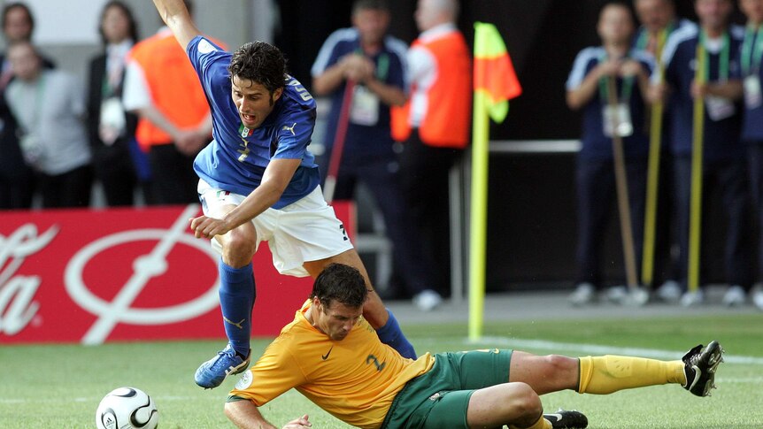 Italy's Fabio Grosso falls over Australia's Lucas Neill in the round of 16 World Cup match in 2006.