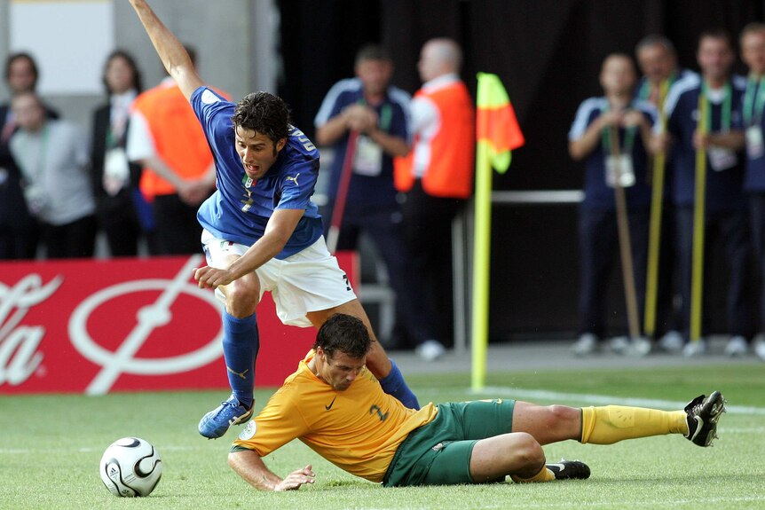 Italy's Fabio Grosso falls over Australia's Lucas Neill in the round of 16 World Cup match in 2006.