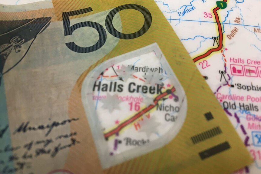 Image of a fifty dollar note placed on a map of the Kimberley, with Halls Creek visible through the clear window.