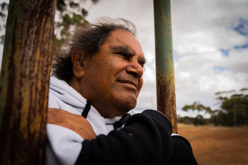 Aboriginal man looking over old mission.