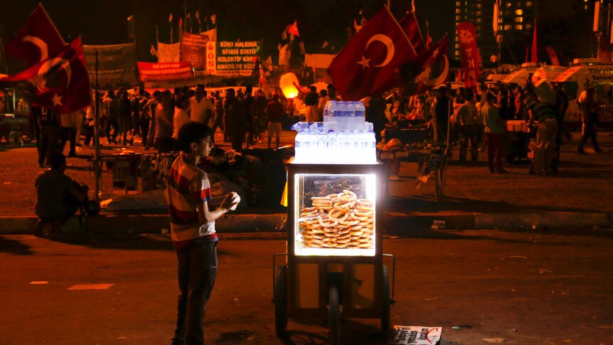 A boy sells snacks and water in Taksim Square during protests.