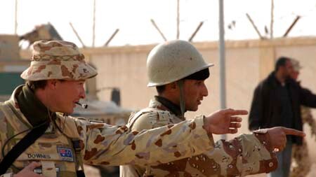 Symbolic presence: An Australian soldier trains one of his Iraqi counterparts