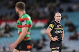 One NRL player looking at an opponent, who is walking off the field (backturned) after being sin-binned