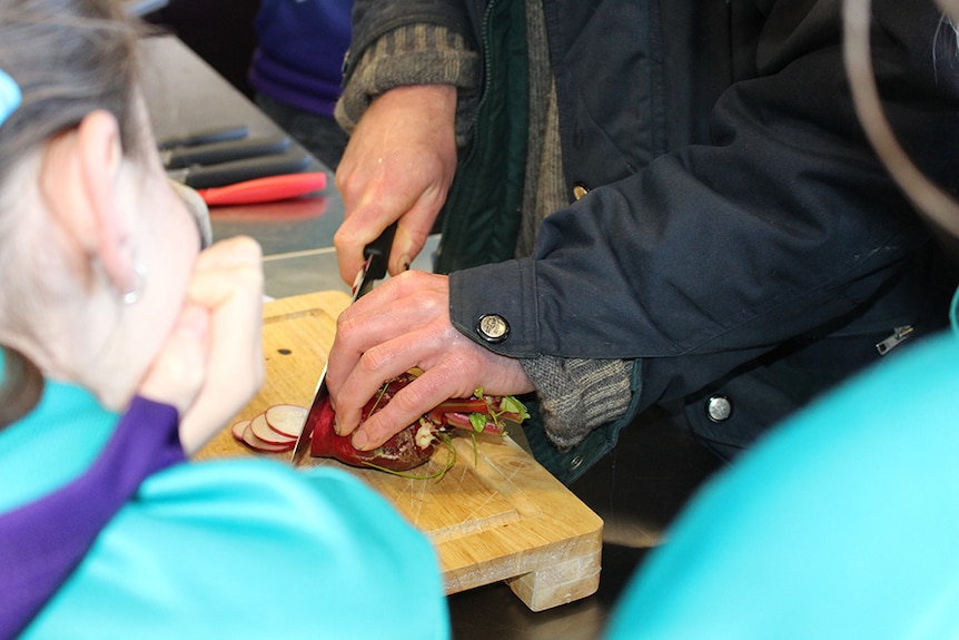 Vegetable preparation being shown to students