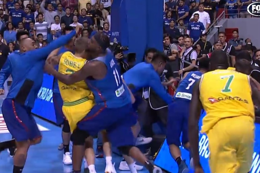 Australian and Filipino basketballers fight in their FIBA World Cup Asian qualifying match.