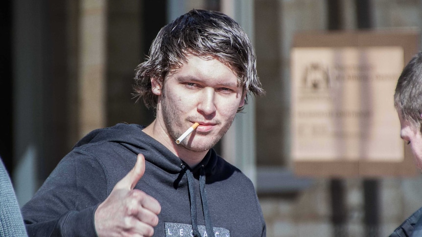 Man with cigarette outside court