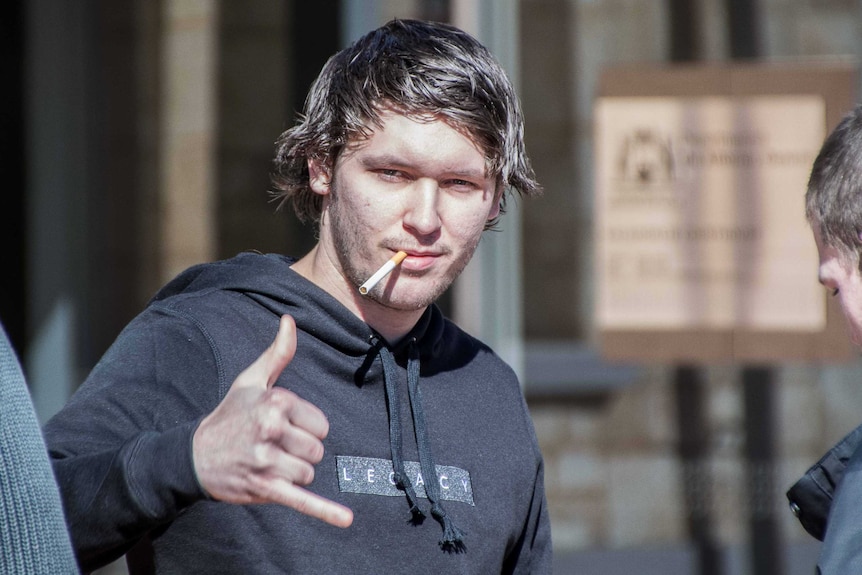 Man with cigarette outside court