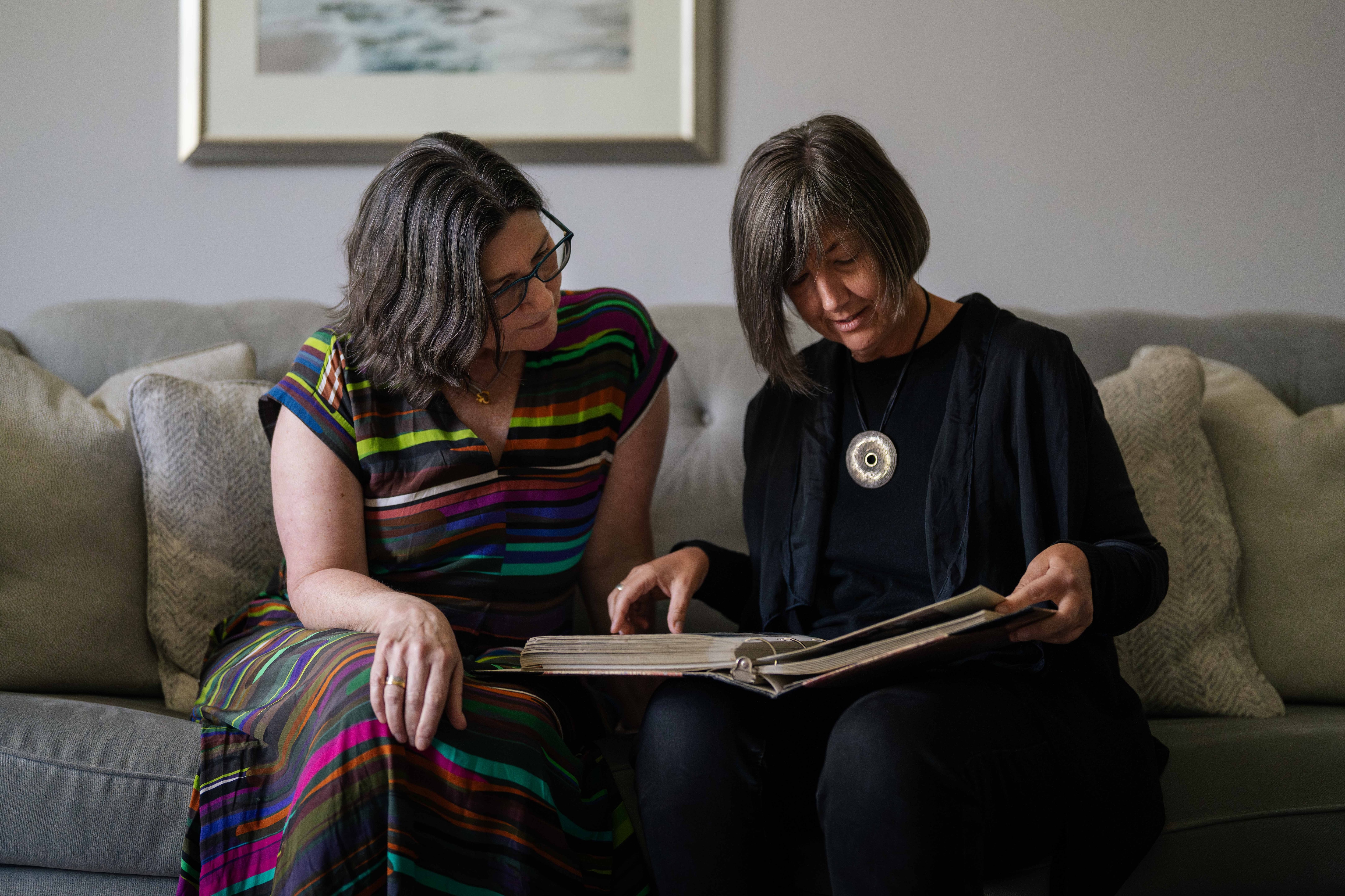 Women look at a photo album